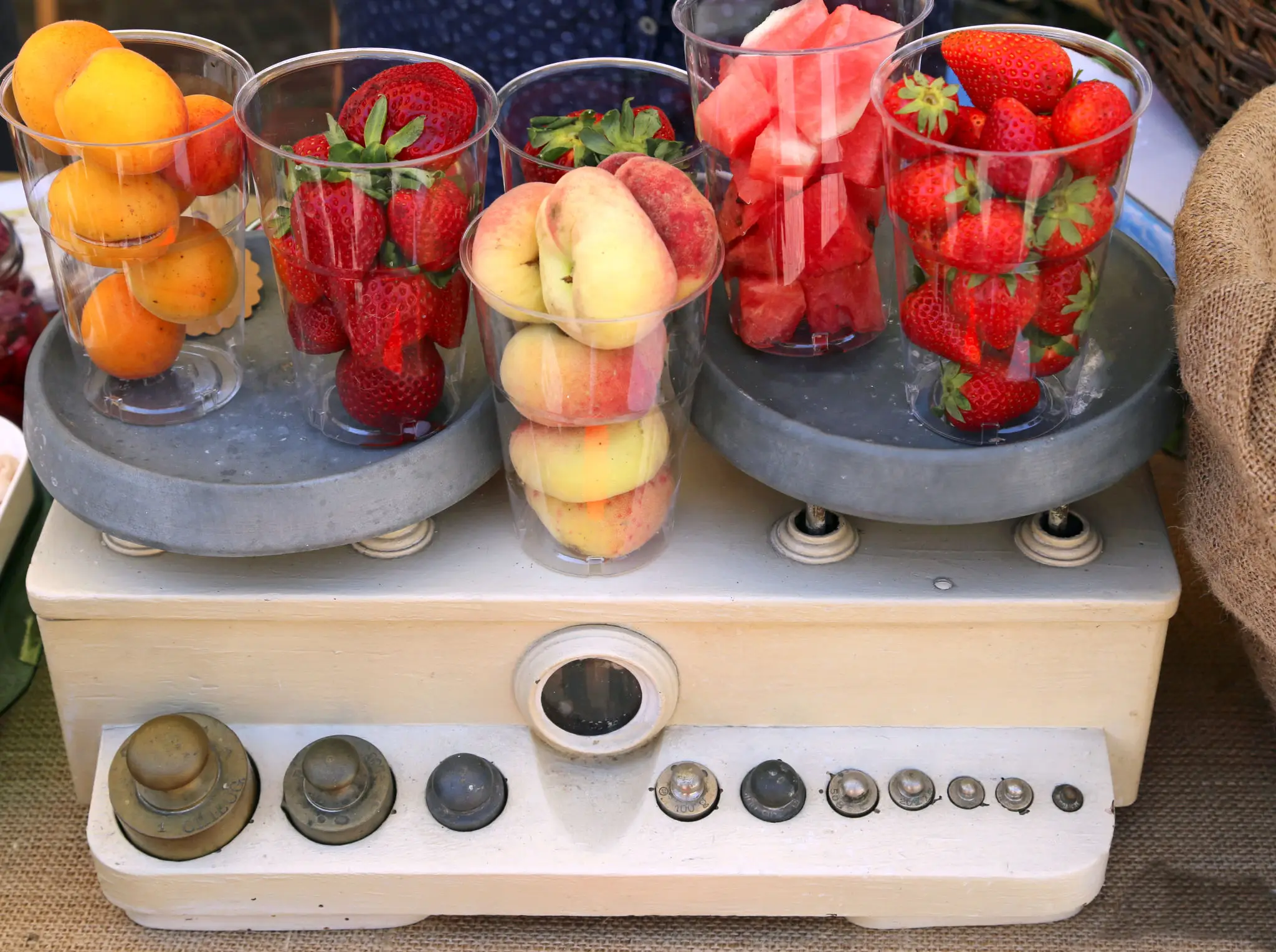 Assorted fruits displayed creatively on scale